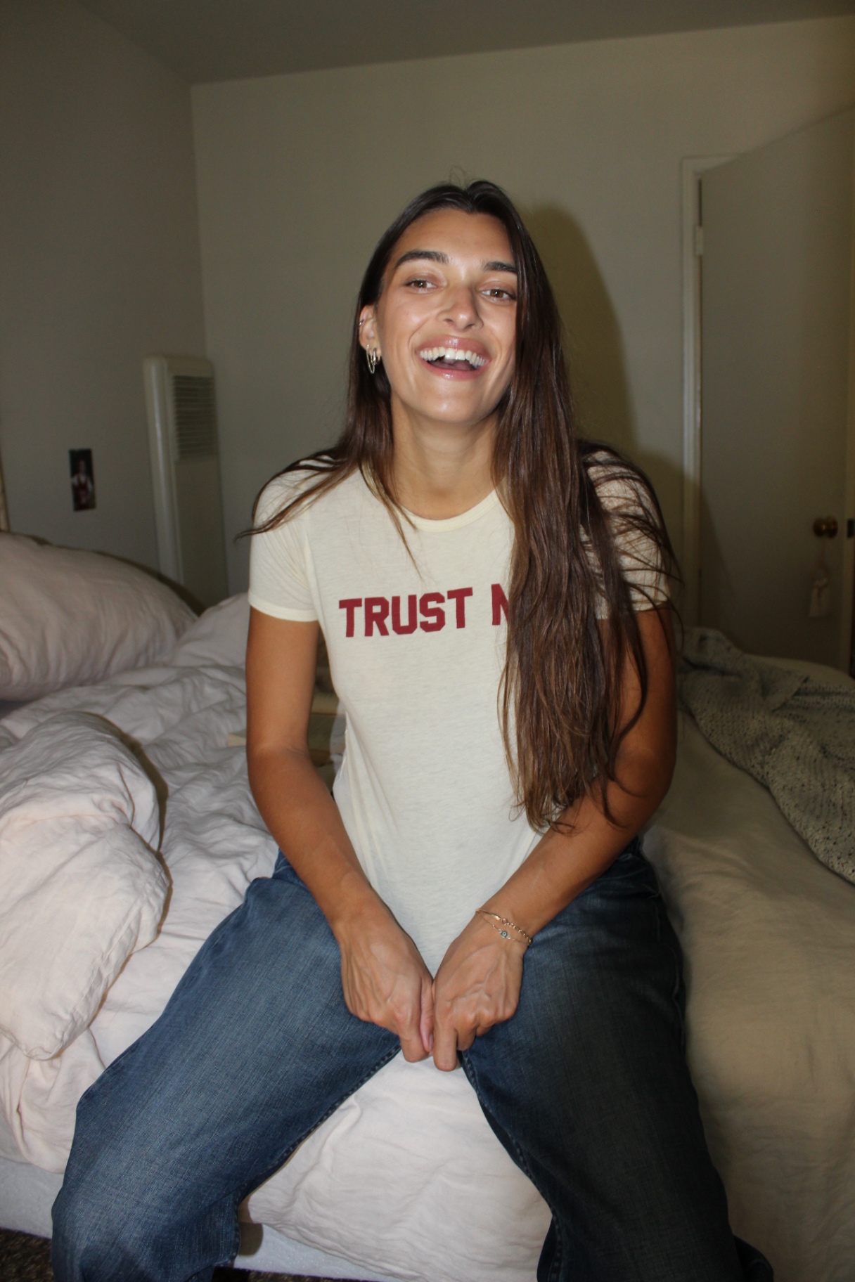 Zoe laughing on bed